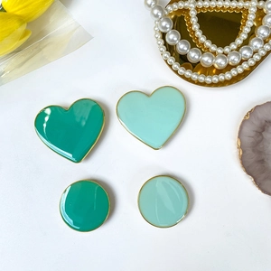 Close-up of heart and round drip glue phone sockets in dark and mint green with gold edges