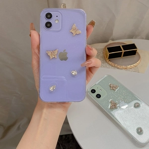Close-up of glitter iPhone case with sparkling rhinestone butterfly and jewel accents