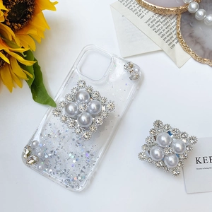 Detail showing luxury square pearl and rhinestone retractable phone socket stand