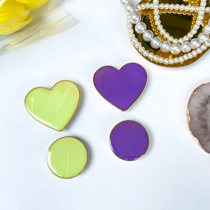 Close-up of heart and round phone sockets in green and purple with gold edges