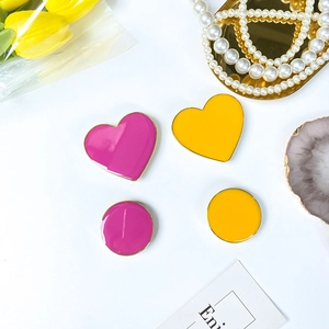 Close-up of heart and round phone sockets with gold edges and glossy enamel finish