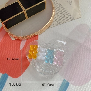 Macro shot of glitter heart phone stand with gummy bear charms and size dimensions
