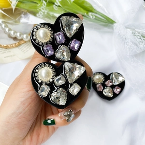 Detailed view of luxury heart phone grip with sparkling rhinestones and pearl inlay