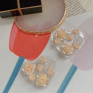 Close-up of heart-shaped resin phone grips with 3D rose and butterfly detailing