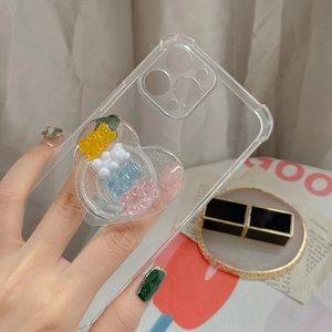 Close-up of clear phone case with heart-shaped grip and colorful resin bears