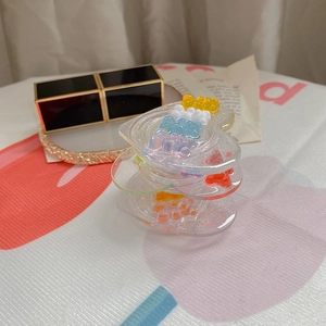 Detail of heart-shaped glitter acrylic phone grip with colorful resin gummy bears