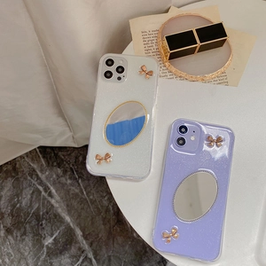 Glitzernde iPhone 16 Pro Max Hülle mit Spiegel und goldenen Schleifen in Silber und Lila