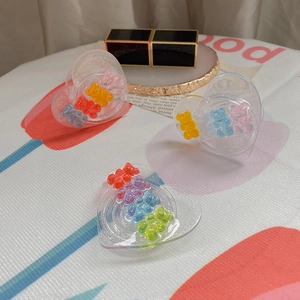Detail of heart-shaped resin phone grips featuring colorful 3D bear candy decorations