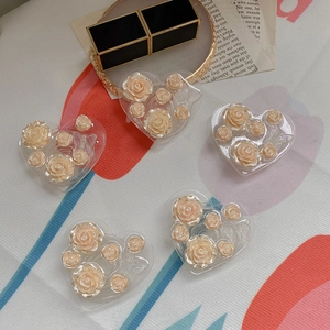 3D rose and butterfly heart phone grip with vintage resin flowers on desktop