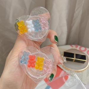 Detail of heart-shaped resin phone grips with colorful gummy bears and gold glitter