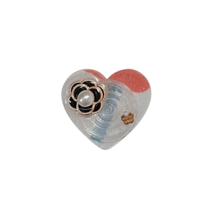 Supporto per telefono a cuore glitterato con camelia 3D e perla su sfondo bianco