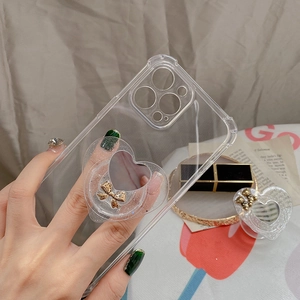 Detail of glitter heart phone stand with mirror and bow on clear protective case
