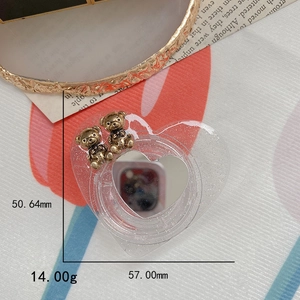 Detail showing dimensions of heart-shaped glitter phone stand with golden mini bears