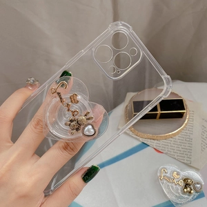 Close-up of heart-shaped phone grip with vintage gold bear and Love lettering detail