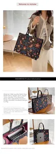 Detail view of large navy canvas tote bag with floral embroidery showing size and capacity