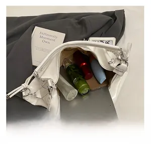Macro shot of spacious white tote bag interior storing an iPad and cosmetics