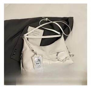 Detail view of white Hobo bag with side woven rope, small zip pocket and clear card holder