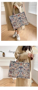 Close-up of floral embroidery on vintage jacquard tote bag with golden charm detail