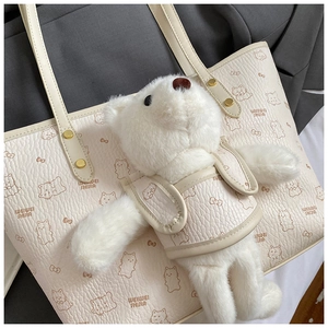 Detail of lychee pattern PU leather bag with cute plush bear and cat graphic prints