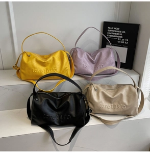 Detail of multi-color tote bags featuring love 105 degree embossed texture and soft leather