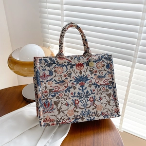 Vintage floral and bird jacquard canvas tote bag with elegant golden brand tag