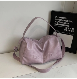 Detailed view of the purple tote bag with love 105 embossed lettering and soft texture