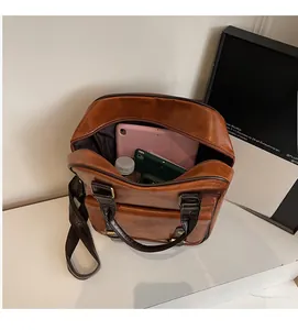 Interior view showing the large capacity of the brown faux leather backpack for daily items