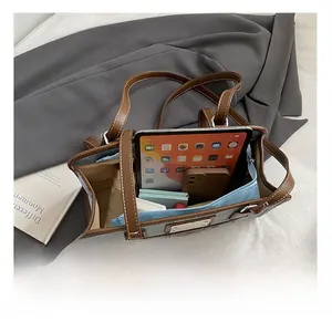 Interior view of spacious color-block tote bag showing iPad and phone storage