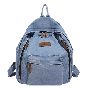 Large vintage light blue denim backpack with multi-pocket design and leather accents