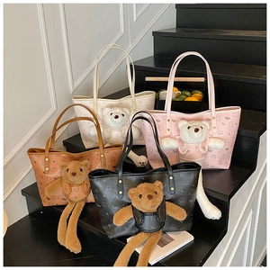 Detail view of four colorful bear pattern tote bags with matching plush teddy bear charms