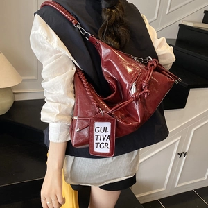 Large capacity burgundy glossy leather hobo bag with woven strap and knot detail