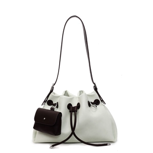 Minimalist cream drawstring bucket bag with brown strap and small side pouch charm