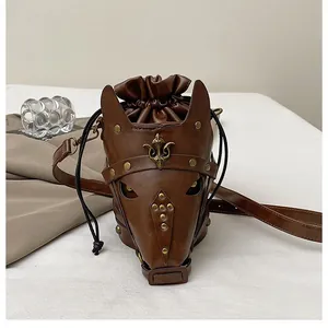 Detailed view of horse head crossbody bag with brass rivets and fleur-de-lis logo