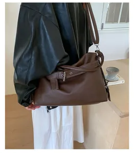 Detailed view of the dark brown lychee leather tote with adjustable wide shoulder strap