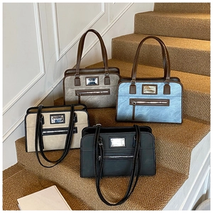 Detail of four retro bow lace tote bags with metal nameplates on warm stairs