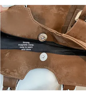 Close-up of the vintage brown leather tote bag showing its strong magnetic clasp closure