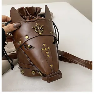 Close-up of a vintage horse head shaped bag with bronze studs and drawstring closure