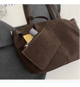 Detail of dark brown faux suede tote bag with small matching hanging zipper pouch