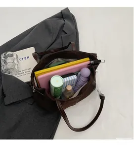 Spacious interior of brown suede tote bag showing storage for laptop and daily essentials