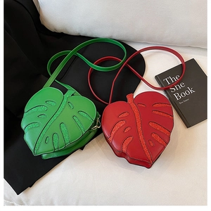 Detailed view of monstera leaf crossbody bag with vein texture and glitter finish