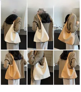 Detailed views of woven large hobo tote bags in white and brown worn by a model