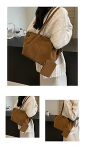 Detail of vintage brown suede tote bag featuring a matching small pouch for daily commute