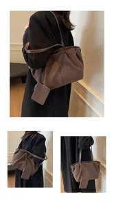 Close-up of matte suede tote bag in dark coffee with matching detachable pouch detail