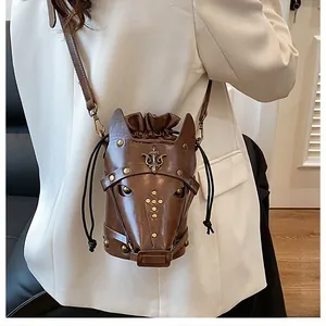 Detail of horse head shaped brown crossbody bag with gold studs and drawstring closure