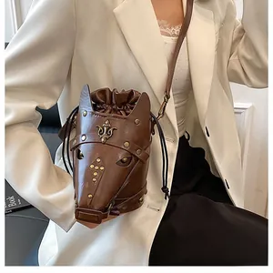 Close-up of vintage horse head shaped crossbody bag with gold rivets and leather texture