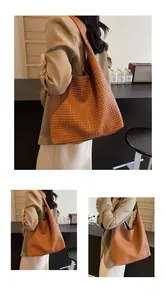 Detailed close-up of woven texture and brown leather strap on retro tote bag
