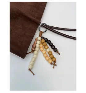 Detailed close-up of multi-colored wooden bead pendants with vintage ethnic textures