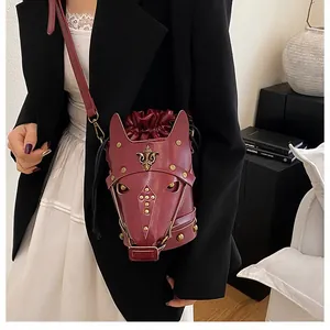 Detailed side view of horse head shoulder bag with gold studs and red matte leather