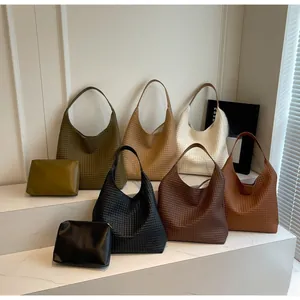 Detailed close-up showing woven leather texture of the large tote and matching pouch