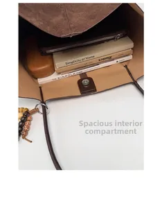 Top view of spacious brown tote bag interior with magnetic closure and inner pouch